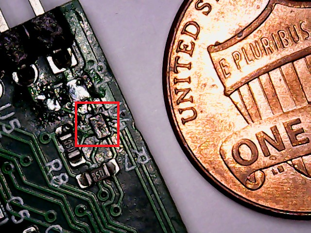The MAX40204 outlined in red, with a US Cent for scale